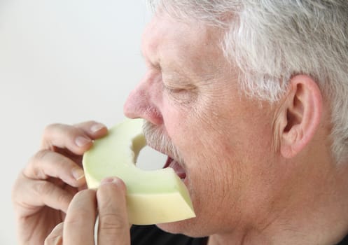 senior man eats fresh melon