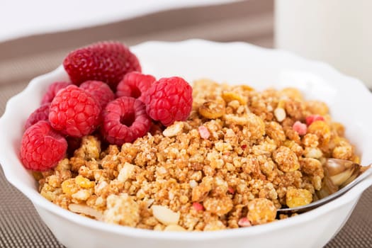 Zoomed shapy cereals with berries with chromed spoon