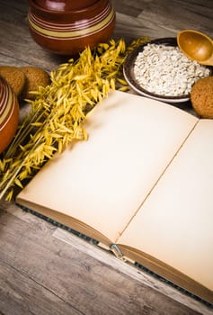 Oatmeal cookies and an old recipe book on the kitchen table