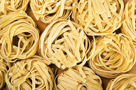 Raw tagliatelle close-up background