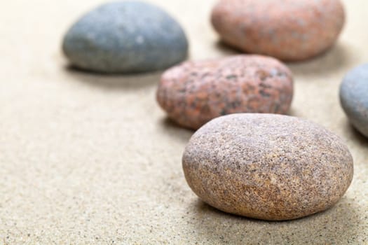 Pebble stones background with copy space. Sand beach texture. Macro shot