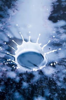 Close view of a droplet of milk hitting a hard surface.