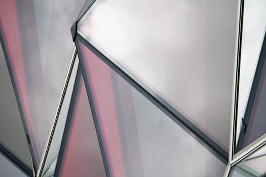 View of a curious modern building with red glass windows.