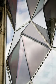 View of a curious modern building with red glass windows.