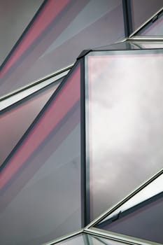 View of a curious modern building with red glass windows.