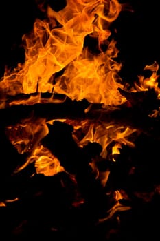 Close view of a wood fire at night.