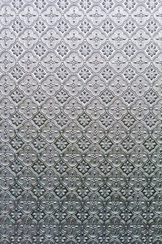 Close view of the flower texture in a glass window.