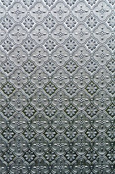 Close view of the flower texture in a glass window.
