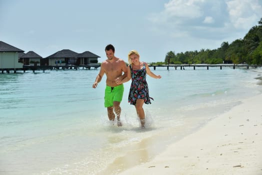 happy young  couple at summer vacation have fun and relax at beautiful sunny  day on beach