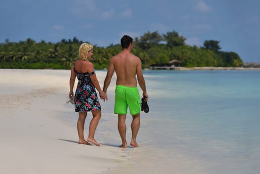 happy young  couple at summer vacation have fun and relax at beautiful sunny  day on beach