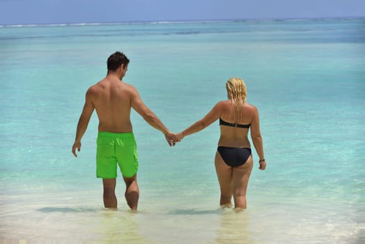 happy young  couple at summer vacation have fun and relax at beautiful sunny  day on beach