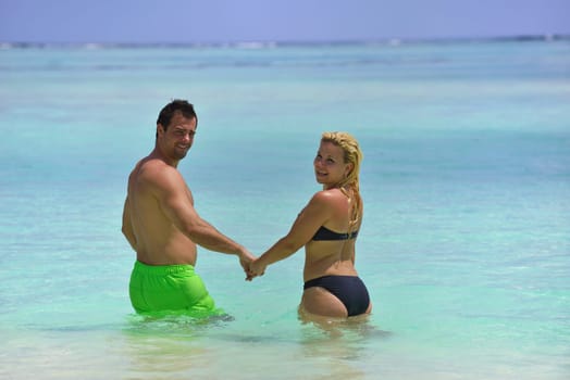 happy young  couple at summer vacation have fun and relax at beautiful sunny  day on beach
