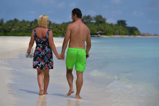 happy young  couple at summer vacation have fun and relax at beautiful sunny  day on beach