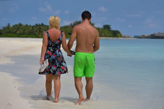 happy young  couple at summer vacation have fun and relax at beautiful sunny  day on beach