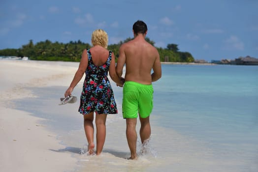 happy young  couple at summer vacation have fun and relax at beautiful sunny  day on beach