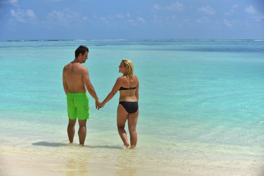 happy young  couple at summer vacation have fun and relax at beautiful sunny  day on beach