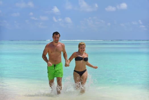 happy young  couple at summer vacation have fun and relax at beautiful sunny  day on beach