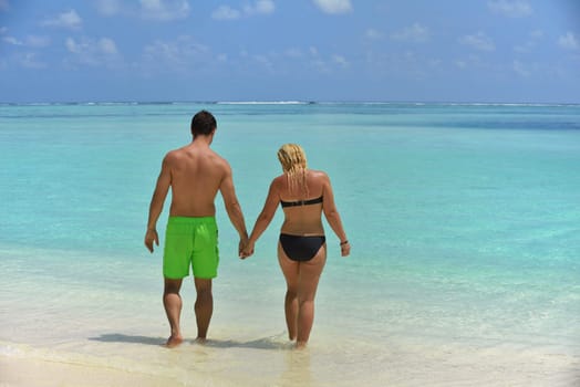 happy young  couple at summer vacation have fun and relax at beautiful sunny  day on beach