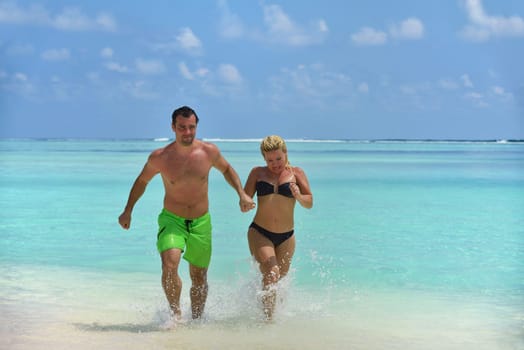 happy young  couple at summer vacation have fun and relax at beautiful sunny  day on beach