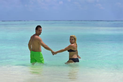 happy young  couple at summer vacation have fun and relax at beautiful sunny  day on beach