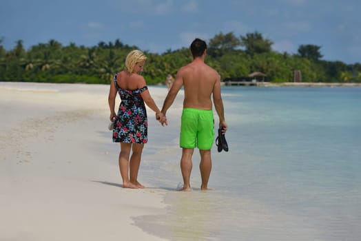 happy young  couple at summer vacation have fun and relax at beautiful sunny  day on beach