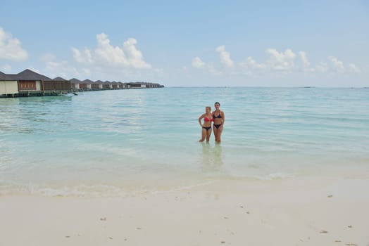 happy young  couple at summer vacation have fun and relax at beautiful sunny  day on beach