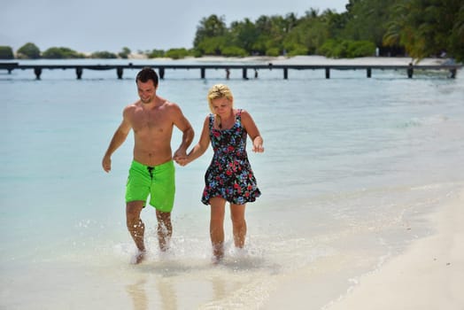happy young  couple at summer vacation have fun and relax at beautiful sunny  day on beach