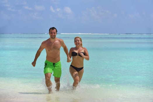 happy young  couple at summer vacation have fun and relax at beautiful sunny  day on beach