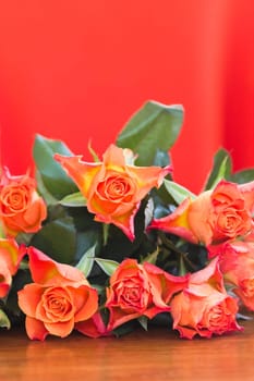 Orange roses with orange background - vertical