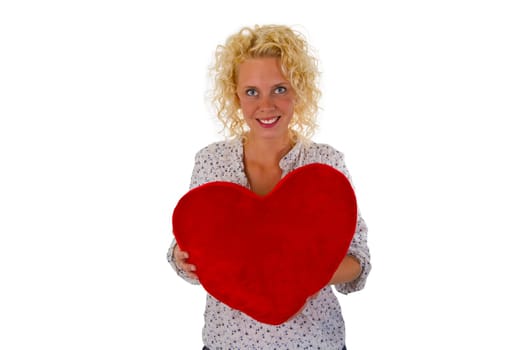 Young attractive woman holds fabric heart exposed on white background