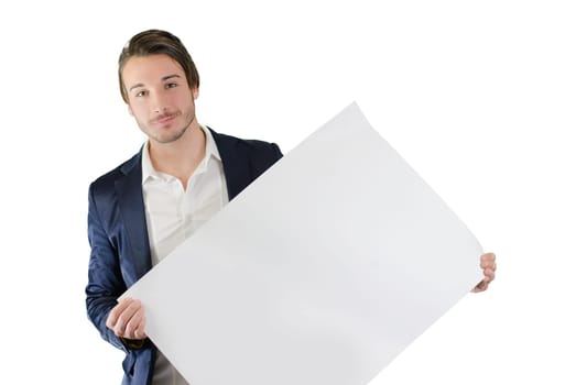 Attractive young man holding and showing empty, blank white board, sign or paper sheet