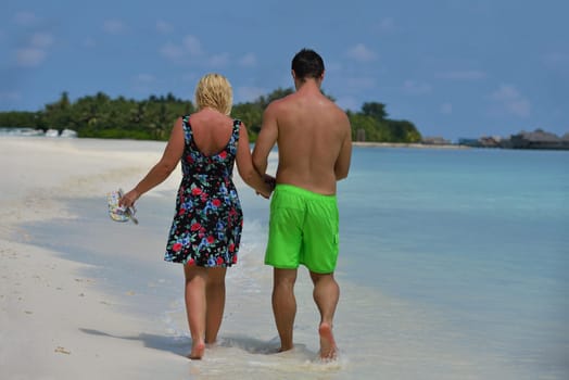 happy young  couple at summer vacation have fun and relax at beautiful sunny  day on beach