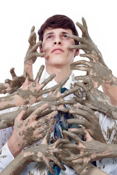 Young man looking up stained by multitude of dirty hands