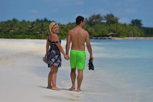 happy young  couple at summer vacation have fun and relax at beautiful sunny  day on beach
