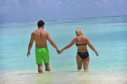 happy young  couple at summer vacation have fun and relax at beautiful sunny  day on beach