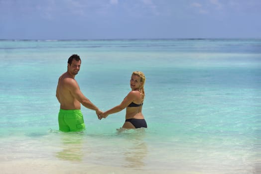 happy young  couple at summer vacation have fun and relax at beautiful sunny  day on beach