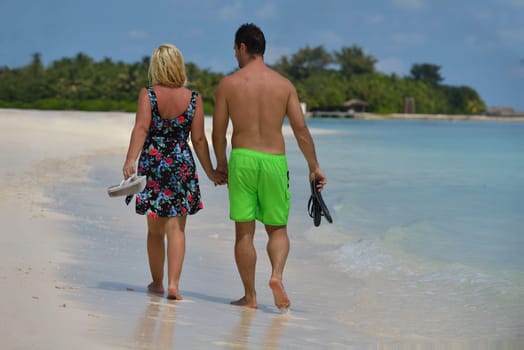 happy young  couple at summer vacation have fun and relax at beautiful sunny  day on beach