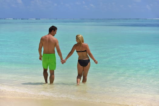 happy young  couple at summer vacation have fun and relax at beautiful sunny  day on beach