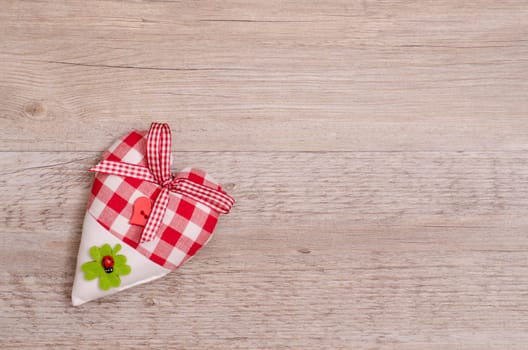 Heart with bow and text space on old wood