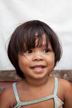 Portrait of an adorable Asian girl from impoverished area in the Philippines.