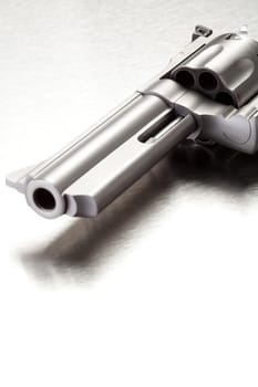 Gun on brushed metal surface - modern revolver with copyspace.