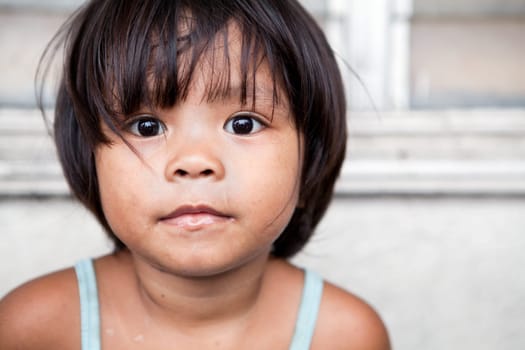 Young girl portrait in the Philippines. Filipina child living in poverty.