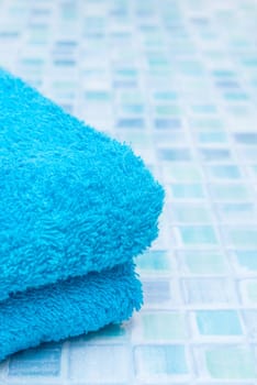 Blue Bath Towels on Blue Bathroom Tiles
