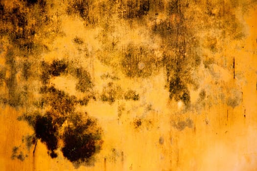 Detail of a weathered yellow wall in Hoi An, Vietnam