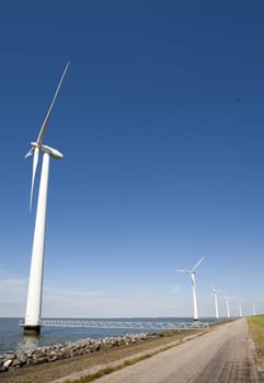 Wind turbines along the dike in the IJsselmeer in Flevoland, the Netherlands