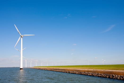 Wind turbines along the dike in the IJsselmeer in Flevoland, the Netherlands