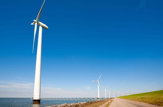 Wind turbines along the dike in the IJsselmeer in Flevoland, the Netherlands