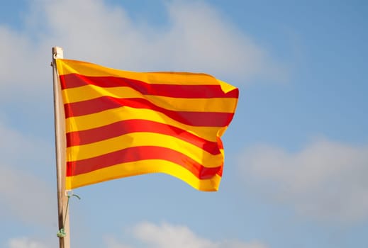 Flag of Catalonia, which consists of four red stripes on a golden background