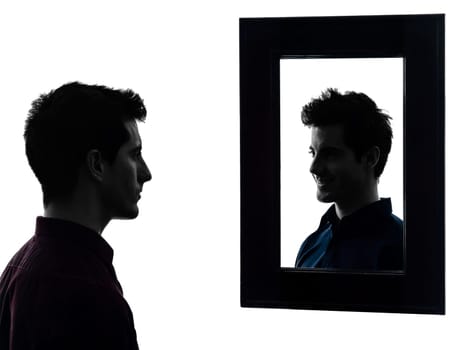 man in front of his mirror serious  in shadow  white background