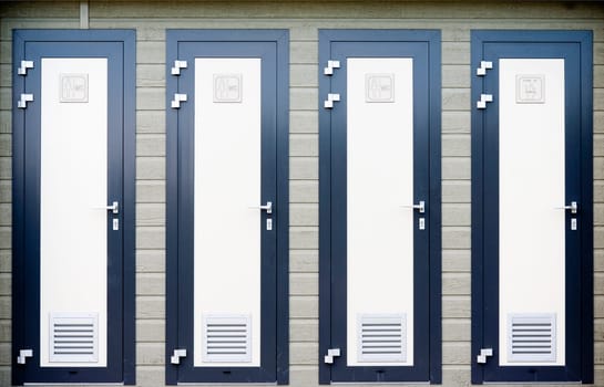 Four bathroom doors in a row